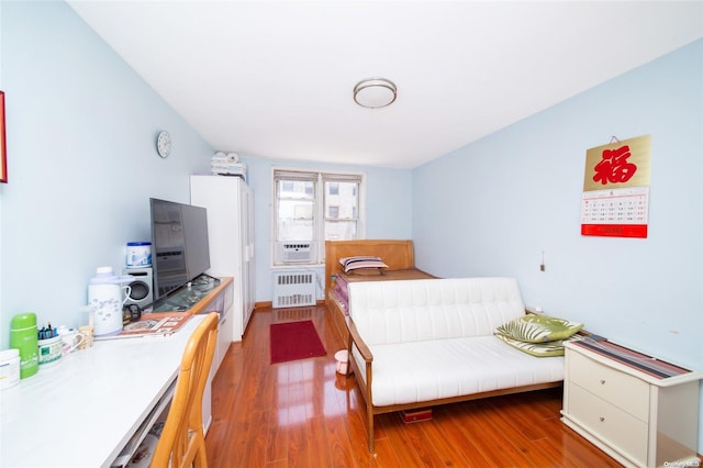 bedroom featuring dark hardwood / wood-style floors and radiator