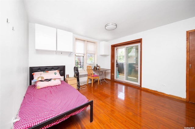 bedroom featuring hardwood / wood-style floors and radiator