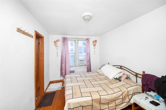 bedroom with wood-type flooring