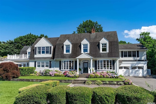 new england style home featuring a garage