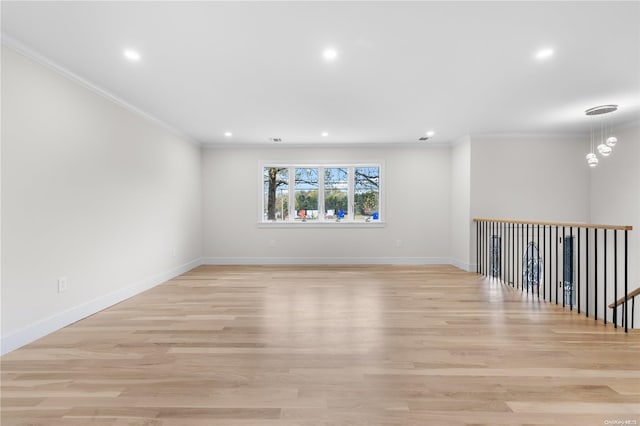 spare room with crown molding and light hardwood / wood-style floors