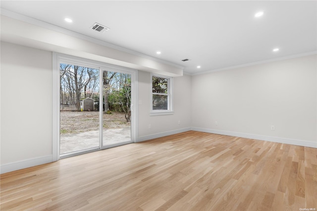 spare room featuring light hardwood / wood-style flooring and ornamental molding