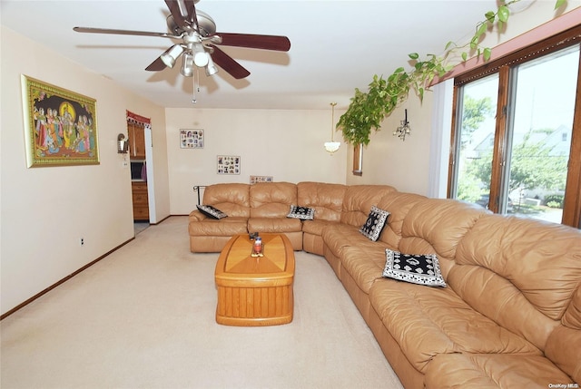 carpeted living room featuring ceiling fan