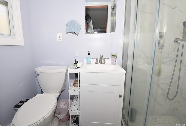 bathroom featuring walk in shower, vanity, and toilet