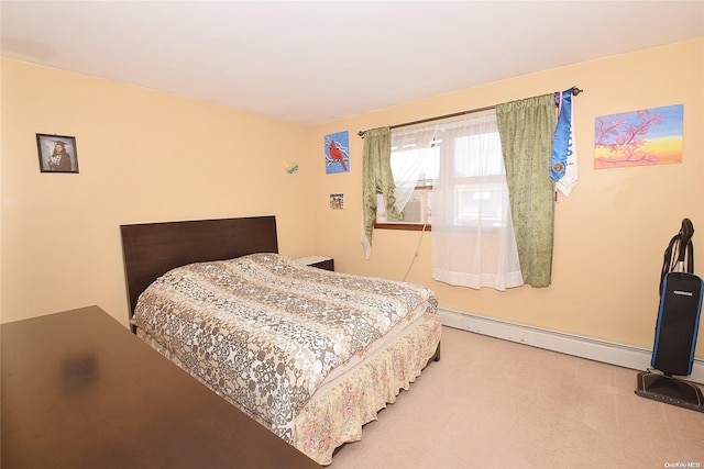 bedroom with carpet flooring and a baseboard radiator