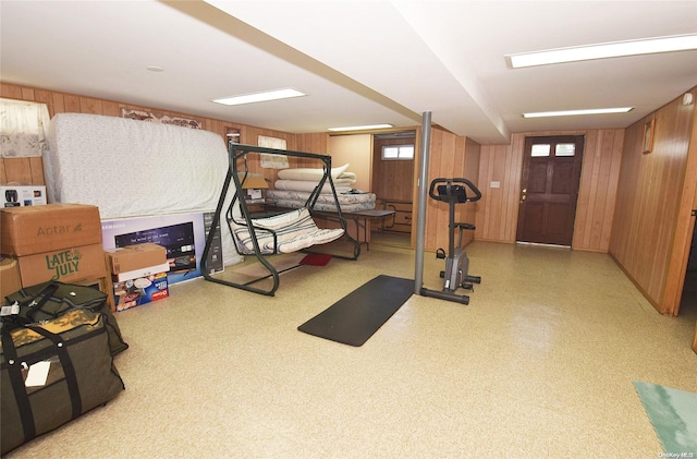 workout area featuring wooden walls