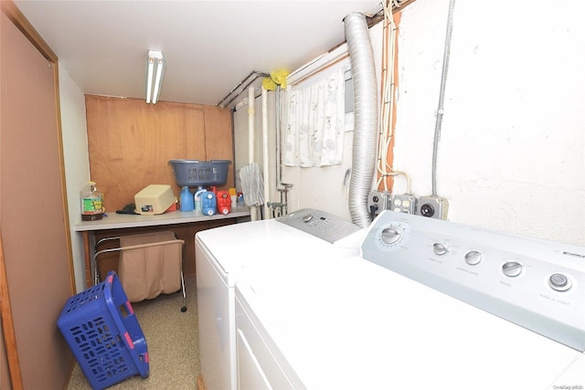 clothes washing area with washer and clothes dryer