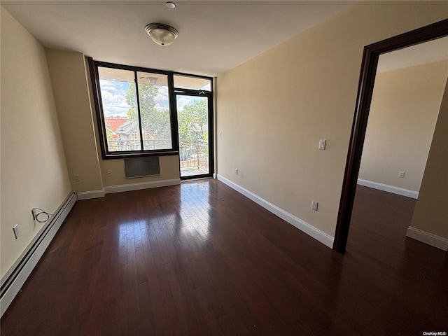 empty room with a baseboard radiator and dark hardwood / wood-style floors