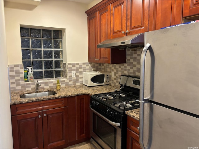 kitchen featuring light stone countertops, sink, ventilation hood, backsplash, and appliances with stainless steel finishes