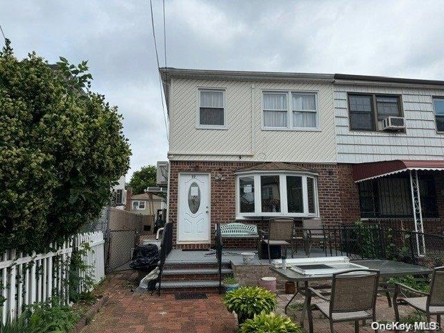 view of front of house with cooling unit and a patio