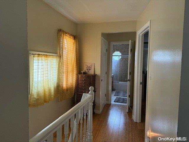 hallway with hardwood / wood-style floors