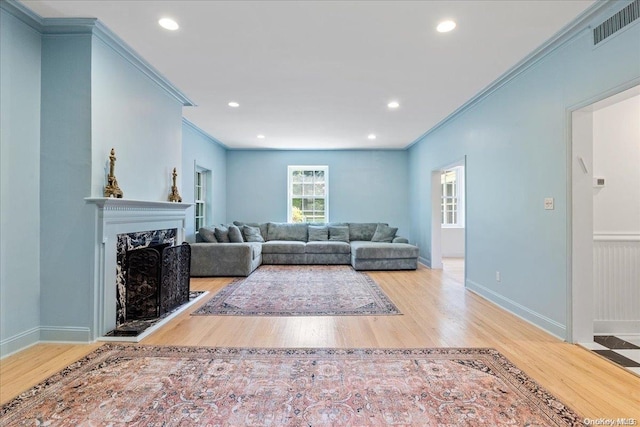 living room with light hardwood / wood-style floors and ornamental molding