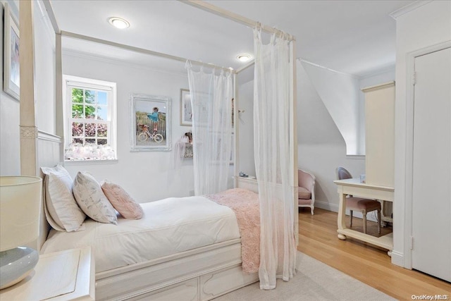 bedroom featuring hardwood / wood-style flooring and ornamental molding