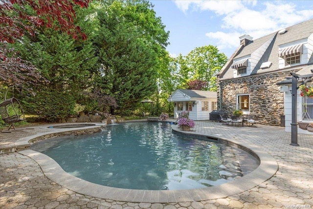 view of pool featuring a patio area, an in ground hot tub, and area for grilling