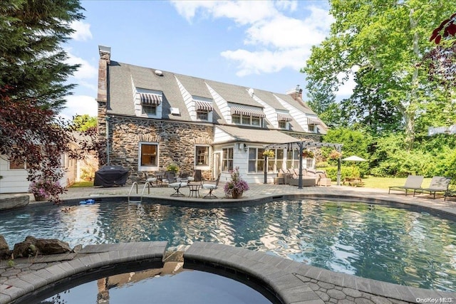 view of pool featuring area for grilling, an in ground hot tub, and a patio