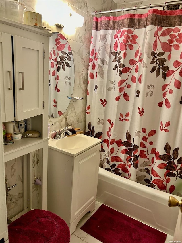 bathroom featuring vanity, tile patterned floors, and shower / bath combo with shower curtain