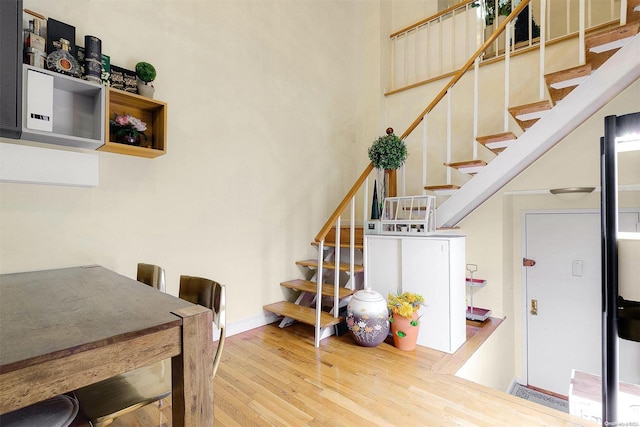 staircase with hardwood / wood-style flooring