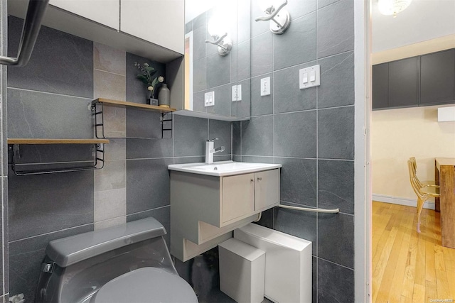 bathroom with wood-type flooring, vanity, and toilet