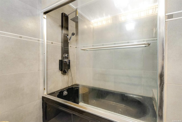 bathroom featuring shower / bath combination with glass door