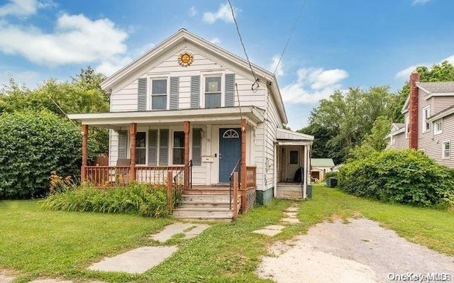 bungalow with a front yard and covered porch