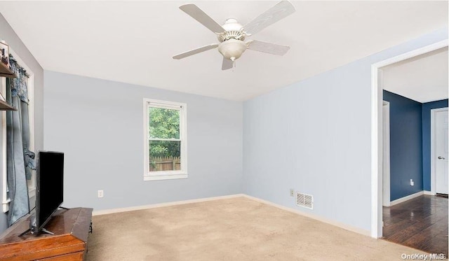 living room featuring ceiling fan and wood-type flooring