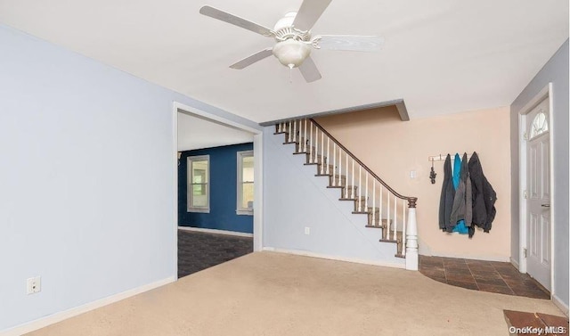 carpeted foyer with ceiling fan