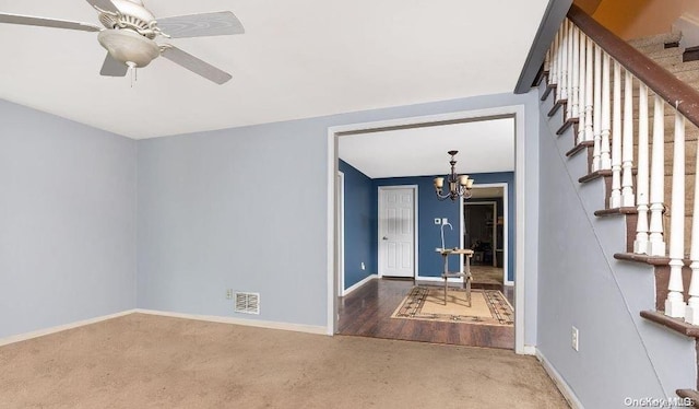 interior space featuring hardwood / wood-style floors and ceiling fan with notable chandelier