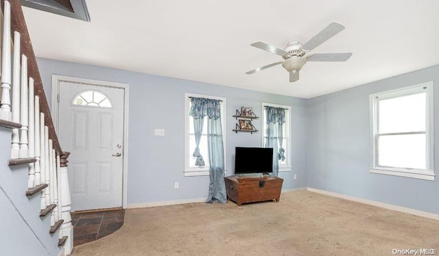 entryway with carpet floors and ceiling fan