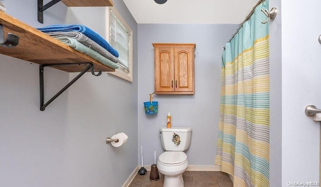 bathroom with toilet and tile patterned floors