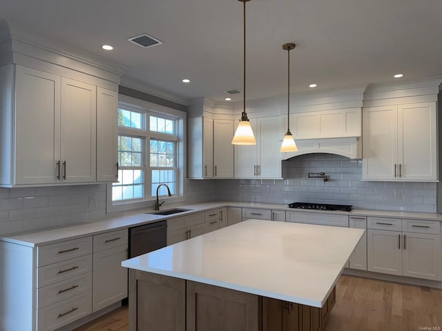 kitchen featuring a center island, white cabinetry, sink, and dishwasher