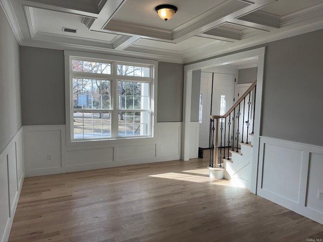 foyer entrance featuring beamed ceiling, coffered ceiling, and ornamental molding