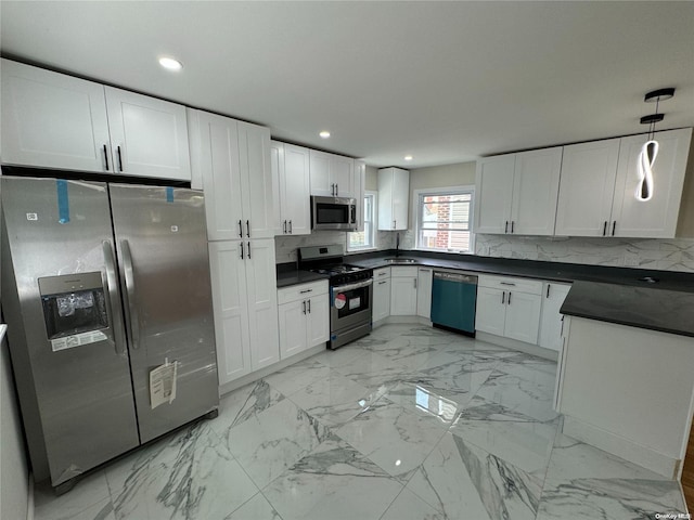 kitchen with appliances with stainless steel finishes, backsplash, decorative light fixtures, and white cabinetry