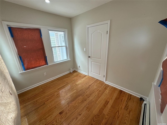 interior space with baseboard heating and wood-type flooring