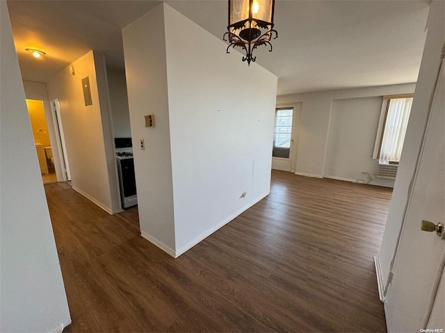 interior space featuring cooling unit, dark wood-type flooring, and an inviting chandelier