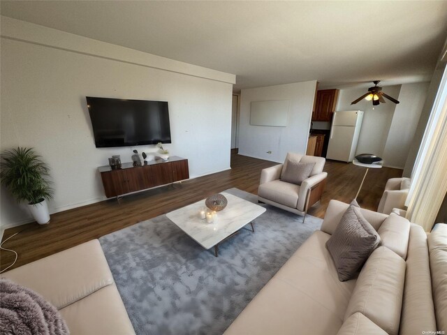 living room featuring dark hardwood / wood-style floors and ceiling fan