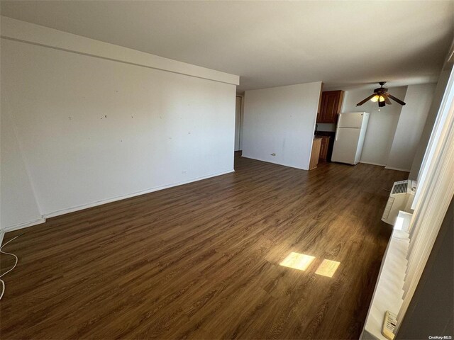 unfurnished living room with dark wood-type flooring