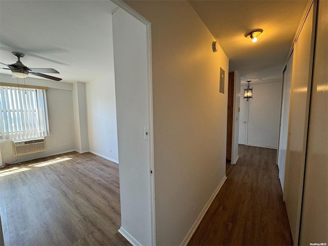 hallway with a wall mounted AC and dark wood-type flooring