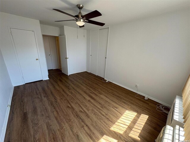 unfurnished bedroom featuring ceiling fan, dark wood-type flooring, and a closet