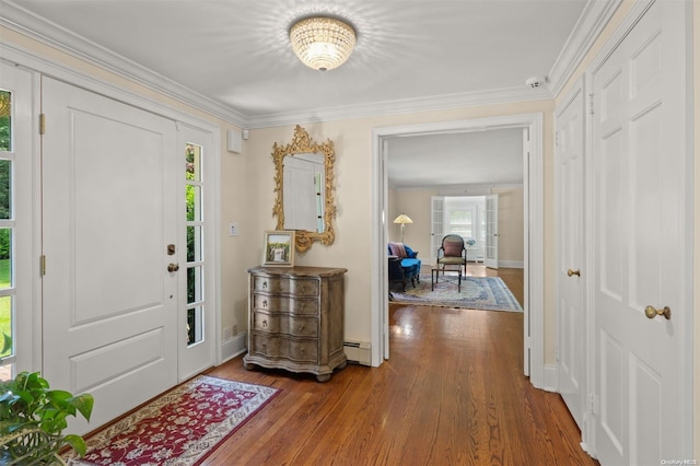 foyer featuring hardwood / wood-style floors, a chandelier, ornamental molding, and a baseboard radiator