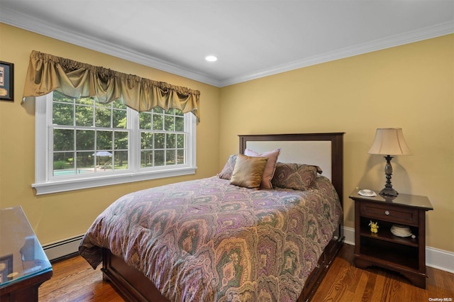 bedroom with hardwood / wood-style flooring, ornamental molding, and a baseboard heating unit