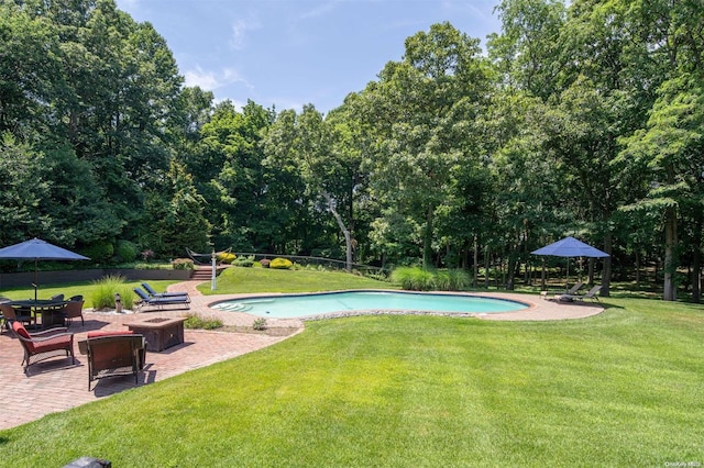 view of swimming pool featuring a yard and a patio