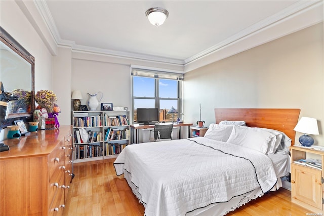 bedroom featuring crown molding and light hardwood / wood-style flooring