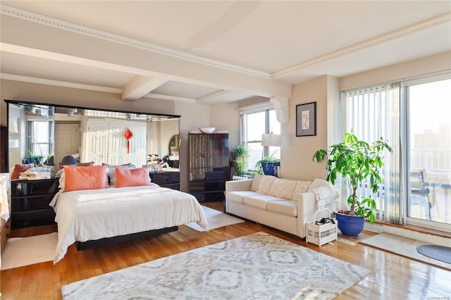 bedroom featuring beamed ceiling and hardwood / wood-style flooring