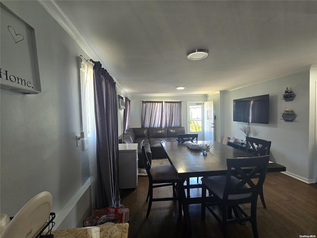 dining room featuring crown molding and dark wood-type flooring