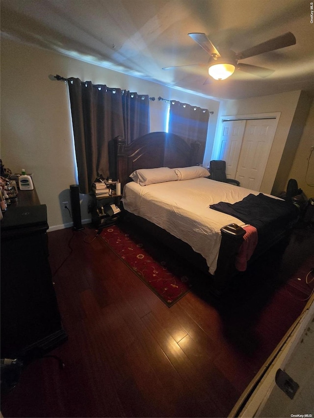 bedroom featuring hardwood / wood-style flooring, ceiling fan, and a closet