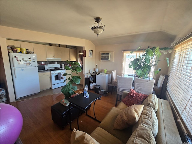 living room with hardwood / wood-style floors, lofted ceiling, washer / clothes dryer, and an AC wall unit