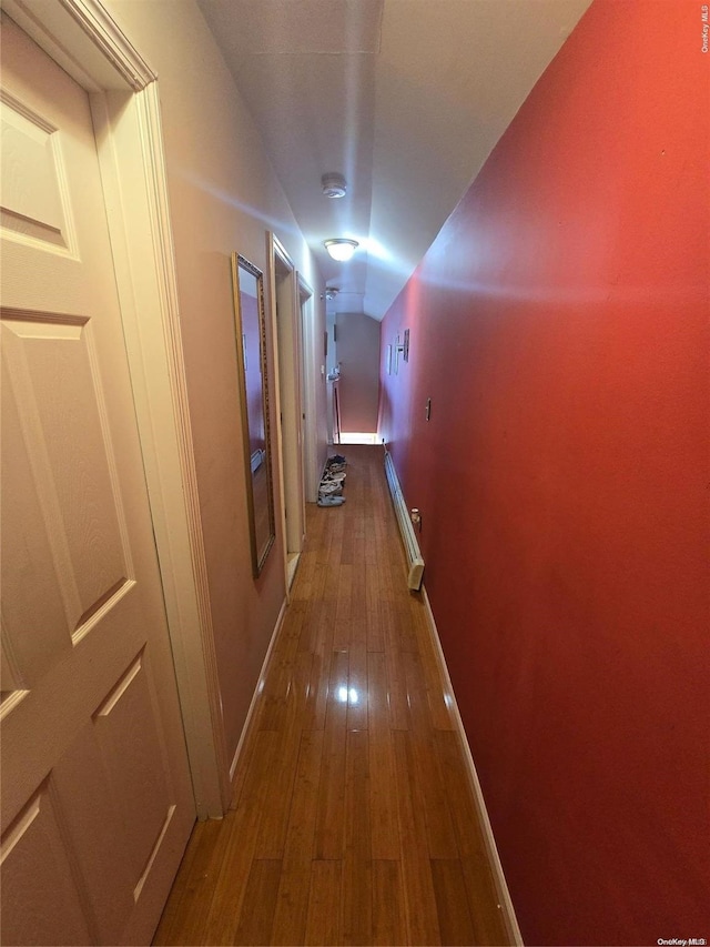 hall featuring baseboard heating and wood-type flooring