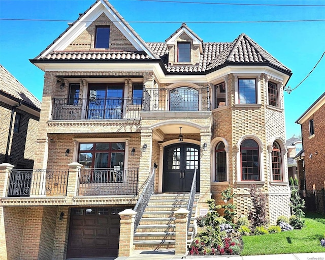 view of front of property with a balcony and a garage