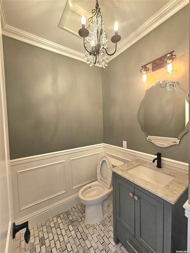 bathroom featuring vanity, crown molding, an inviting chandelier, tile patterned flooring, and toilet