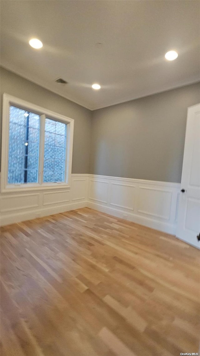 unfurnished room with light wood-type flooring